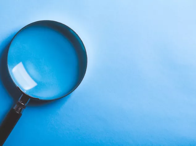 Magnifying glass with blue background