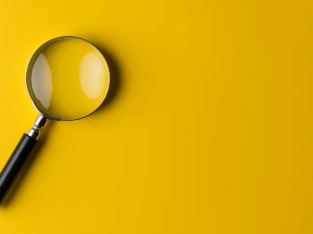 Yellow background with magnifying glass