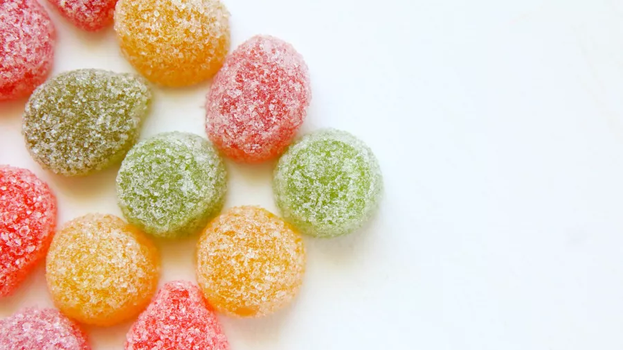 Coloured round gummy sweets coated in sugar