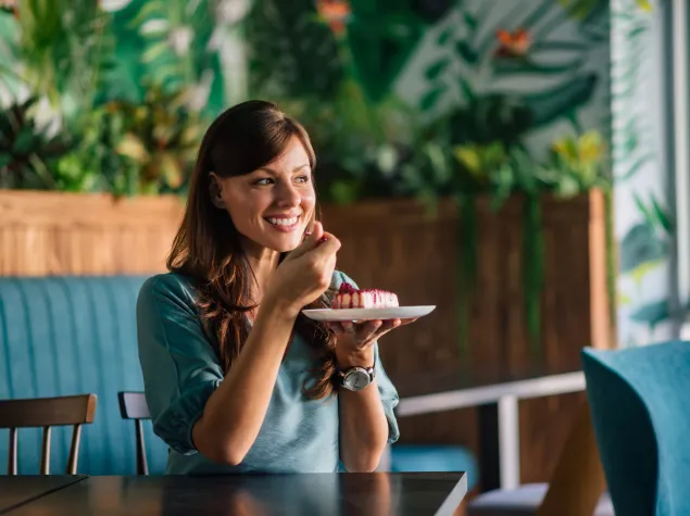 Lady eating cake with a fork