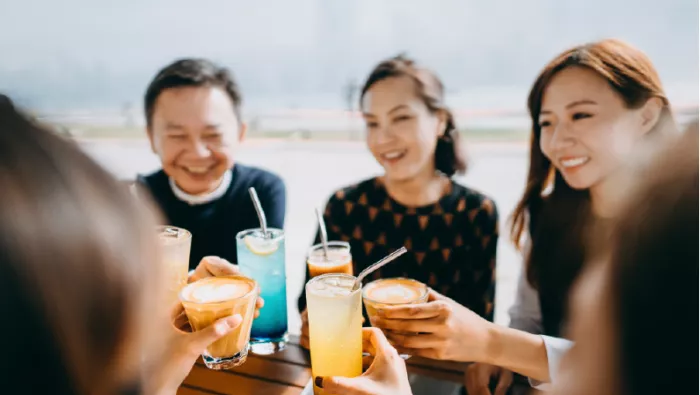 Friends with drinks at table