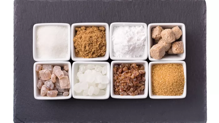 Different types of sugar (white & brown sugar cubes, and granulated sugar))