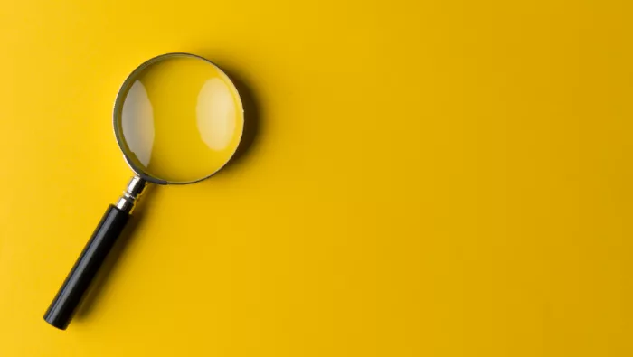 Yellow background with magnifying glass