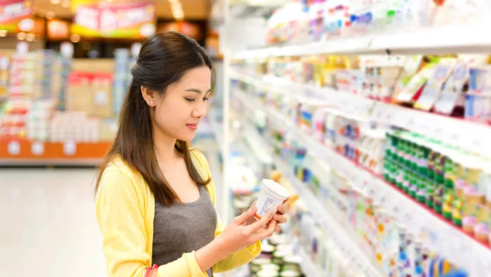 Lady holding yogurt pot