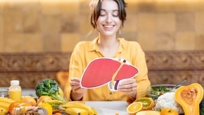 Lady holding image of a liver