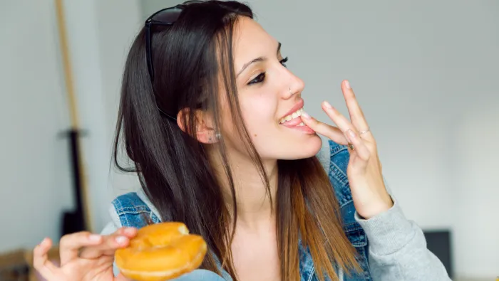 Woman eating doughnut
