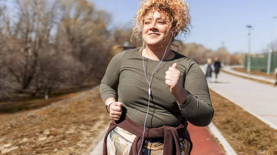 A woman running, listening to music 