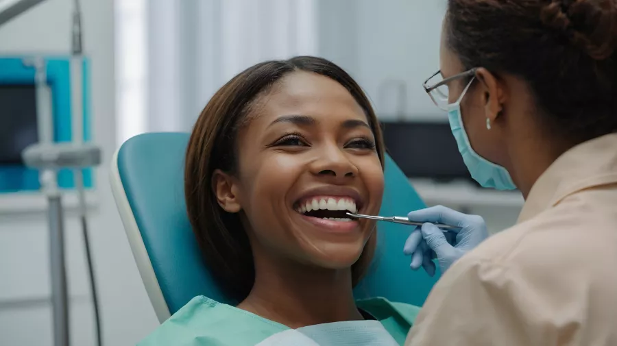 A lady having her teeth checked by the dentist 