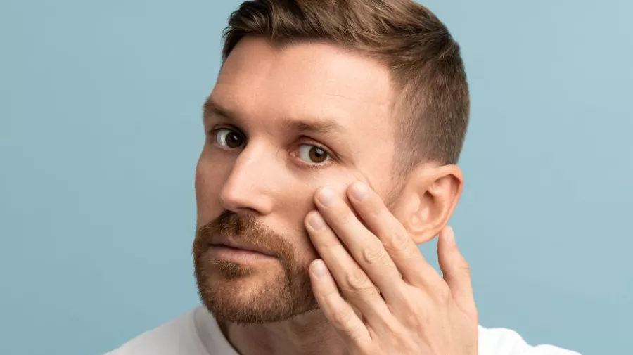 Bearded man looking at wrinkes